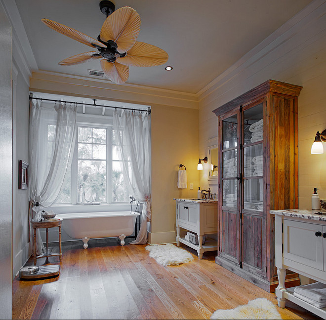 Farmhouse Bathroom Ideas. I find this bathroom so romantic and so inviting! Countertops are Persian Pearl granite. Bathroom sinks are Bates & Bates in Hammered Bronze from Ferguson. Faucets are Rohl in Mayan Bronze. Plantation Farmhouse Bathroom Design Ideas. Beautiful farmhouse bathroom with reclaimed wood cabinet, his and hers vanities and hardwood floors. #Bathroom #Farmhouse #Farmhousebathroom Wayne Windham Architect, P.A. Interiors by Gregory Vaughan, Kelley Designs, Inc. Photos by Atlantic Archives, Inc. 