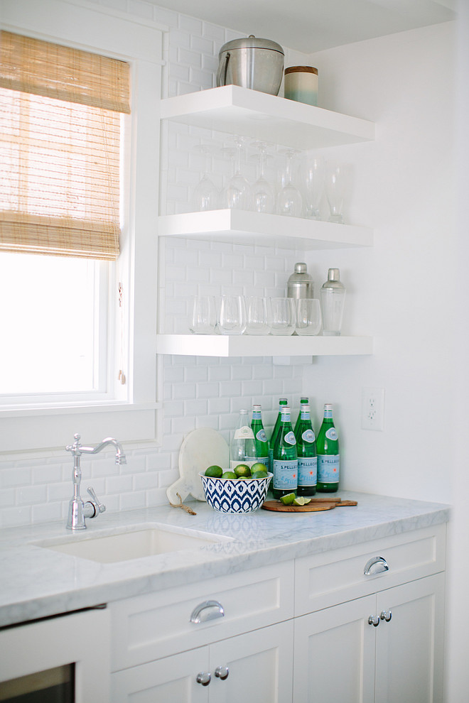 Kitchen Bar. Kitchen Bar Ideas. Kitchen Bar with floating wall shelves, prep sink, white marble countertop and beveled subway tile backsplash. #KitchenBar #KItchen #Bar Rita Chan Interiors.