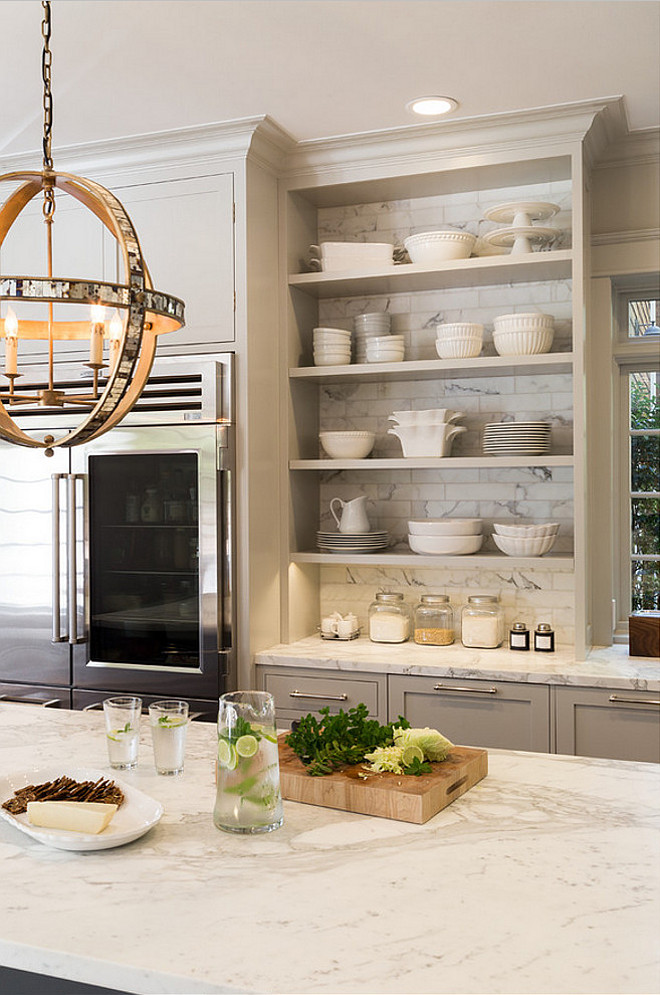 Kitchen Bookshelf with tiles. Kitchen bookshelf cabinet with tiled back. The open bookshelf cabinet in this kitchen features Calacatta d'Oro marble tiles in a 3"x6" size. #Kitchen #Bookshelf #Tiles #CalacattadOro #Marble Heydt Designs. Benjamin Dhong Interiors.