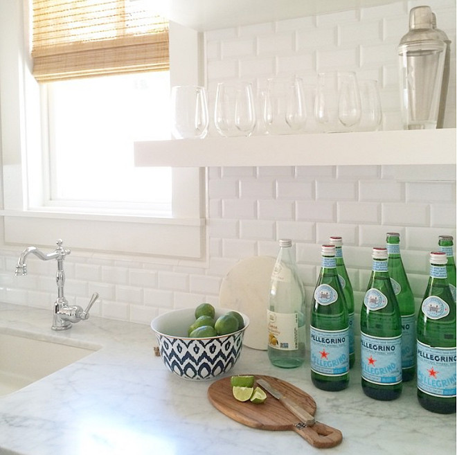 Kitchen prep sink with floating shelves and white tile backsplash. Kitchen backsplash is Beveled 2x4 White Subway Tiles. #Kitchen #prepsink #floatingShelves #KitchenFloatingShelves Rita Chan Interiors.