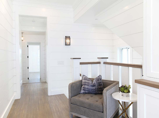 Reading Area above stairway. White shiplap walls reading area. Graystone Custom Builders.