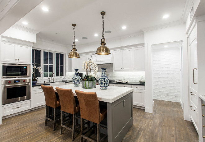 White Kitchen gray island. White coastal kitchen with gray island and painted brick backsplash. White Kitchen. #WhiteKitchen #CoastalKitchen #Grayisland Blackband Design.