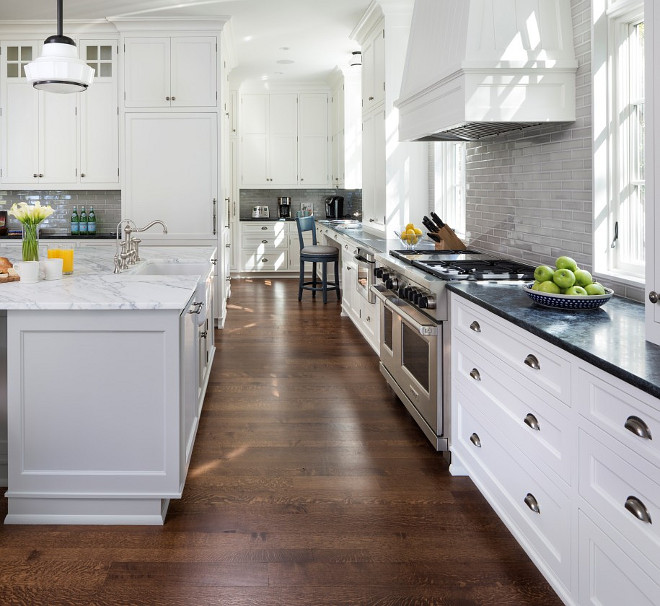 White Kitchen with pale gray island. Classic white kitchen cabinets with gray kitchen island. #WhiteKitchen #gray #island John Kraemer & Sons.