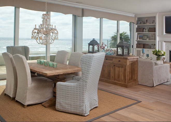 Coastal Dining room with shell chandelier and slipcovered chairs. #Diningroom #CoastalInteriors #Shellchandelier #slipcoveredchairs AGK Design Studio.