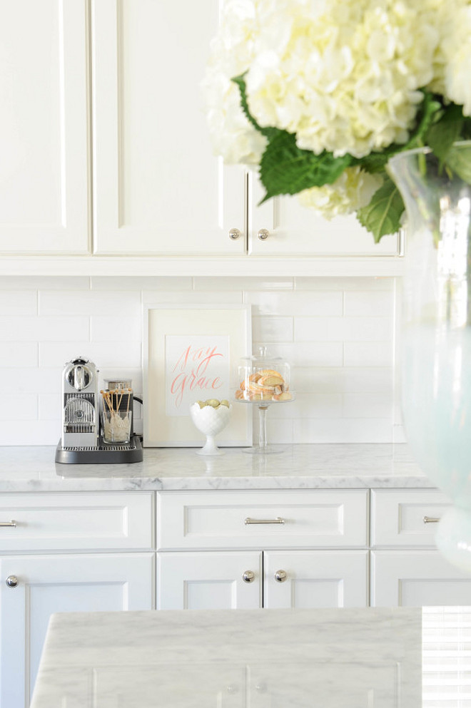 White Kitchen Cabinet with white subway tile backsplash and white marble countertop. Monika Hibbs.