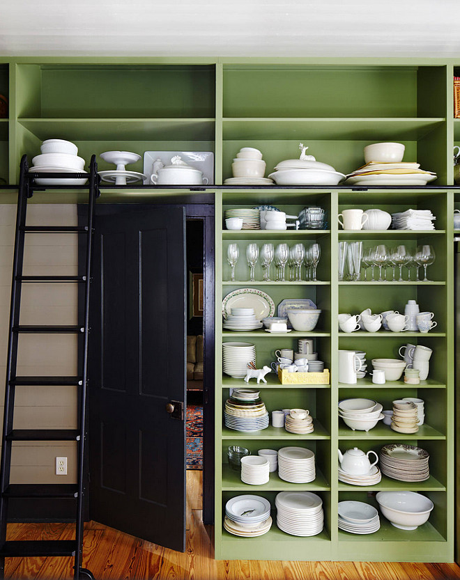 Kitchen with open shelf wall cabinet. Puttnam rolling ladder makes tall shelves accessible. Benjamin Moore Land of Liberty paint color. Door and trim is Benjamin Moore Nightfall. #BenjaminMooreLandofLiberty #BenjaminMooreNightfall Tim Cuppett Architects.