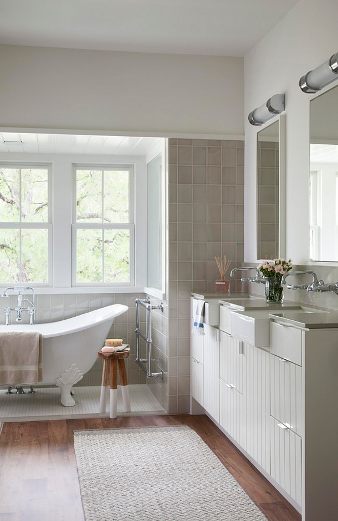 Farmhouse bathroom. Neutral Farmhouse bathroom. This neutral Farmhouse bathroom features floor to ceiling tiles. Tile is Walker-Zanger, Moderne, color Mica. #FarmhouseBathroom #tiles #nerutralbathroom Tim Cuppett Architects.