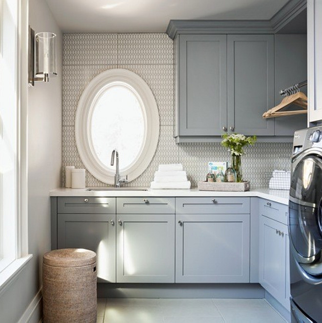Blue-gray laundry room cabinet paint color. Blue-gray laundry room cabinet with quartz countertop. Quartz makes one of the best laundry room countertop choices for its durability. #laundryroom Elizabeth Metcalfe 