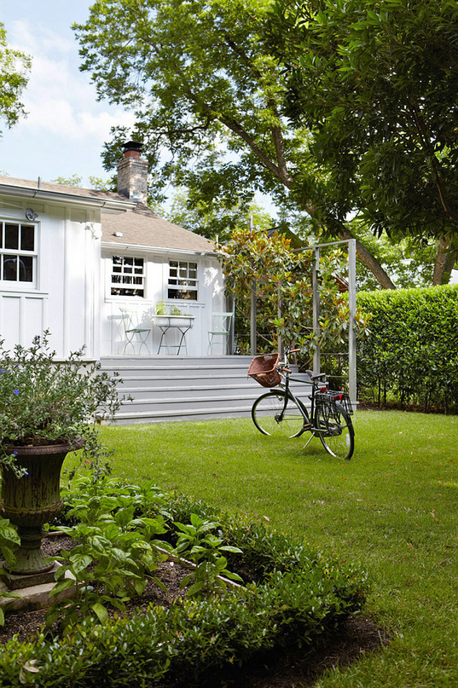 White Cottage Home Exterior. White Cottage Home Exterior Paint Color. White Cottage Home Exterior with gray deck. Deck from white cottage, backyard herb garden. #whiteCottage #exterior Tim Cuppett Architects.