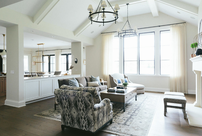 Cabinet between columns. An opening between the living room and kitchen makes the spaces seem bigger and provides storage space. Kate Marker Interiors.