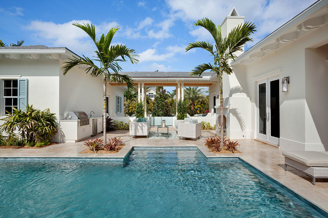 Home with outdoor lounge area and outdoor kitchen. Casatopia, LLC - Ibi Designs