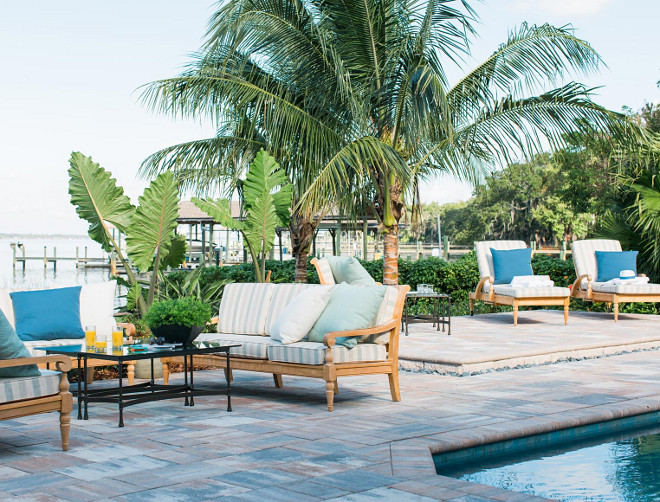 Raised Patio. The raised pool patio and the outdoor living area are separated by a bank of Floridian palm trees to create distinctly different rooms on the lanai.