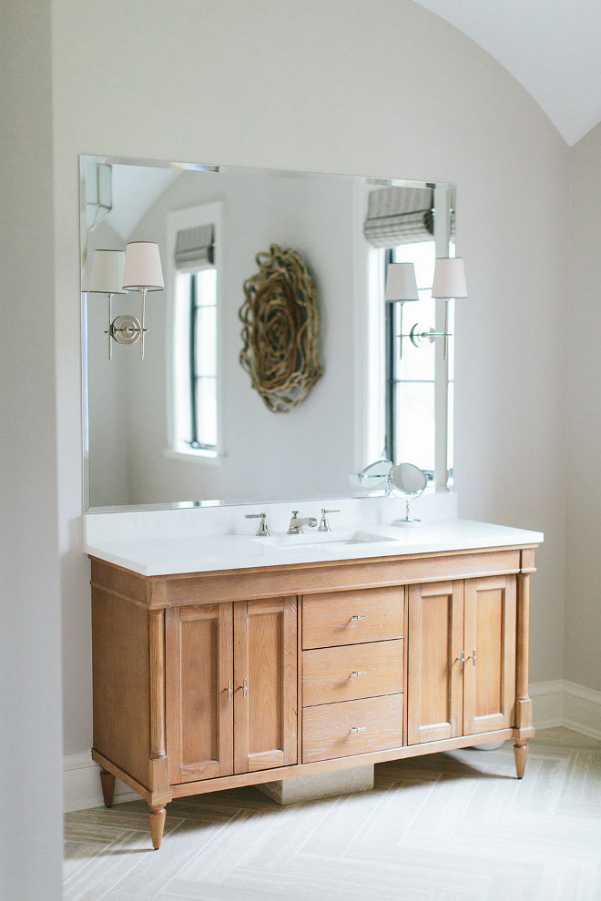 Bathroom Cabinet. White oak bathroom cabinet. White oak bathroom cabinet with marble countertop and herringbone tiles. White oak bathroom cabinet ideas. Whitewashed White oak bathroom cabinet. #Whiteoak #bathroom #cabinet #Whiteoakbathroomcabinet #bathroomcabinet Kate Marker Interiors.