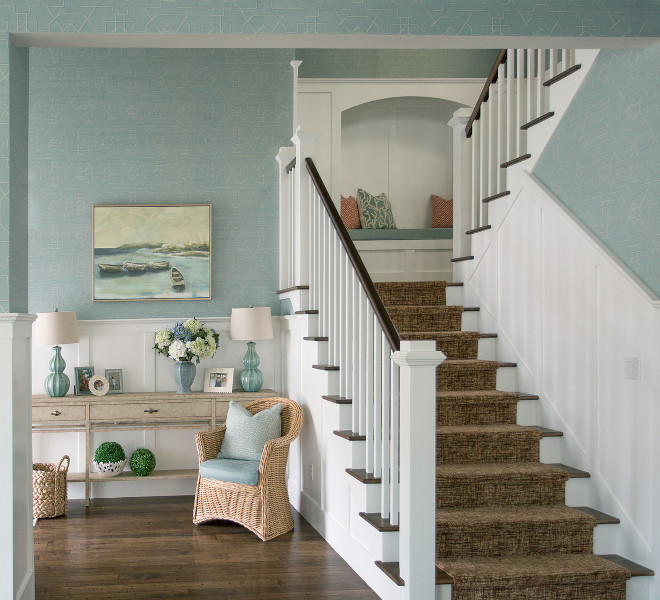 Foyer and staircase ideas A built-in bench on the staircase landing with hidden bookshelves serves as a cozy reading nook or a place to tie shoes before heading out the door #Foyer #staircase #readingnook #starircasereadingnook #staircasebench Alexandra Rae Design