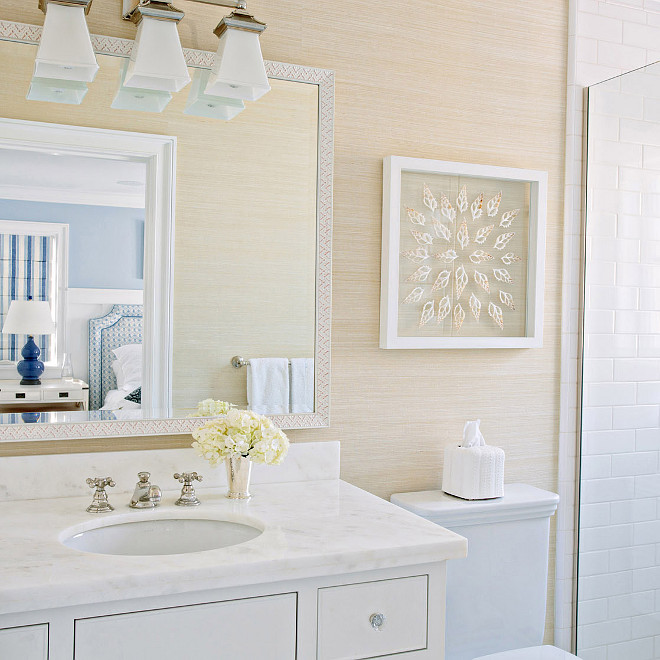 Neutral bathroom features walls clad in tan grasscloth lined with a white washstand with inset drawers topped with white marble nder a mosaic mirror and a 3 light sconce, Triple Chinoiserie Bath Light in Polished Nickel #NeutralBathroom #Bathroom #Grasscloth Waterleaf Interiors