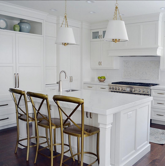 White kitchen with brass accessories. Crisp white kitchen with brass lighting, brass hardware and golden-sprayed counterstools. Kitchen Brass. #KItchenBrass #WhiteKitchenBrass #Whitekitchen #Brass #Brasspendants #brasslighting #BrassHardware Sita Montgomery Design