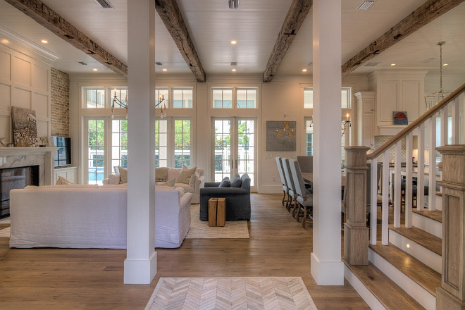 Beach house with reclaimed wood beams and white shiplap walls. 30A Interiors