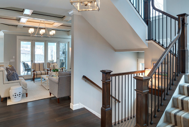 Foyer Design Ideas. Gray foyer painted in Benjamin Moore Silver Chain and a stairway with striped stair runner. #GrayFoyer #paintcolor #Foyer #BenjaminMooreSilverChain