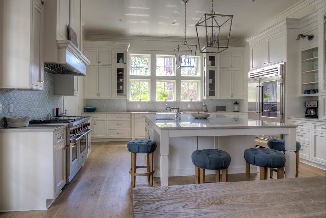 White Kitchen Design. White Kitchen Design with large island and tall cabinets painted in Benjamin Moore White OC-17, the most popular white paint color for kitchens. 30A Interiors