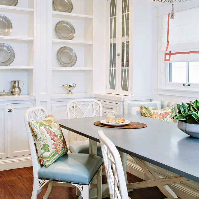 White table with gray top, Breakfast nook features a white distressed table with gray top and white chairs #Whitetable #whitetablegraytop #whitechairs #breakfastnook Waterleaf Interiors