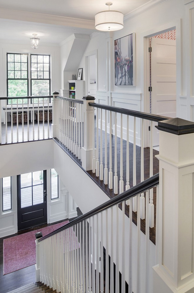 White stairway spindles and newel post painted in Benjamin Moore OC-130 Cloud White. #BenjaminMooreOC130CloudWhite #Whitestairwaypaintcolor #whitestairwayspindles #whitestairwayspindlespaintcolor #whitestairwaynewelpost #whitestairwaynewelpostpaintcolor Spacecrafting Photography. Charlie & Co. Design, Ltd. Kroiss Development, Inc.