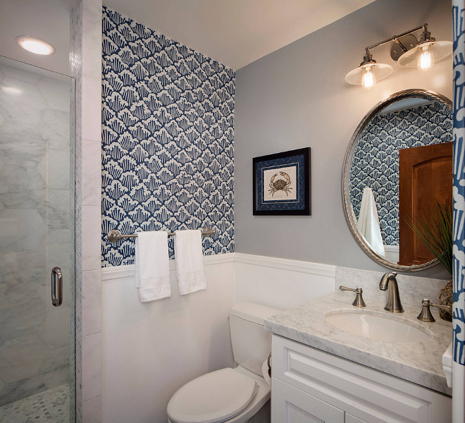 Small bathroom reno ideas. Small bathroom reno. Paint color is Frazee CL3172W Charleston. Wallpaper is Farrow and Ball Aranami. Light fixture is Restoration Hardware 20th C Factory Filament Ribbed Glass Double Sconce - Polished Nickel. Bathroom tiling The shower walls are a large hexagon Carrera tile and the shower floor is a small Carrera hexagon tile. The rest of the bathroom floor is a wood-like plank porcelain tile. #FrazeeCL3172WCharleston CM Natural Designs