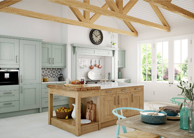 Rustic European kitchen. aga aga over mantel chopping board chopping boards clock exposed beams exposed brick splashback fruit basket fruit bowl jug kitchen beams kitchen island mint green modern kitchen painted brick painted kitchen sage green saucepan rail traditional kitchen Kitchen Stori