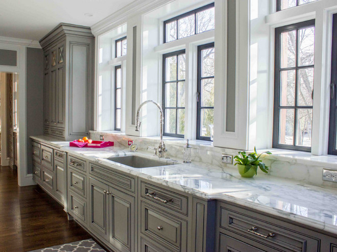 Kitchen window above sink. Kitchen windows above sink. A wall of windows allows natural light to flood the gray kitchen. #Kitchenwindow #Kitchenwindowabovesink Lori Wiles Design