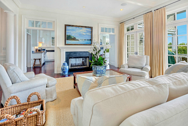 Neutral living room with fireplace and natural fiber rug and basket for throws and magazines. #Livingroom #neutrallivingroom Christie's Real Estate