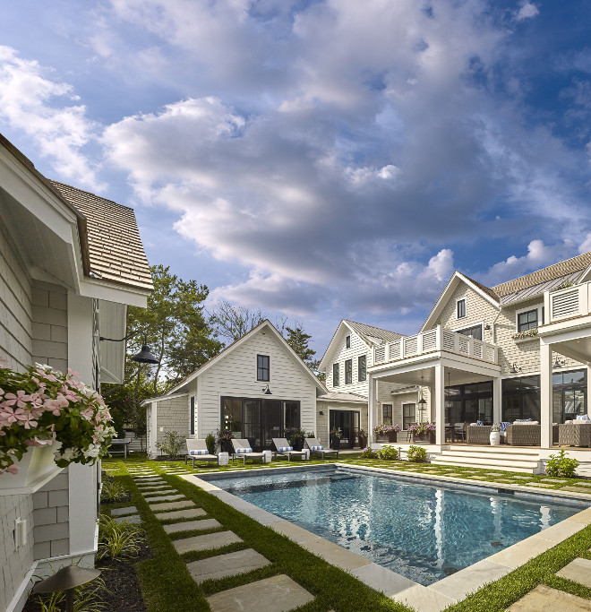 Shingle home backyard. Shingle home pool backyard . Shingle home pool backyard with stone pavers and pool house. #ShingleHome #Backyard #Pool #PoolHouse #StonePavers Asher Associates Architects