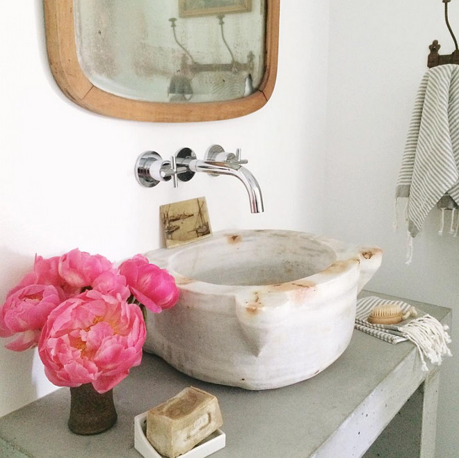 Marble basin with wall mounted bathroom faucet. Heather Bullard.