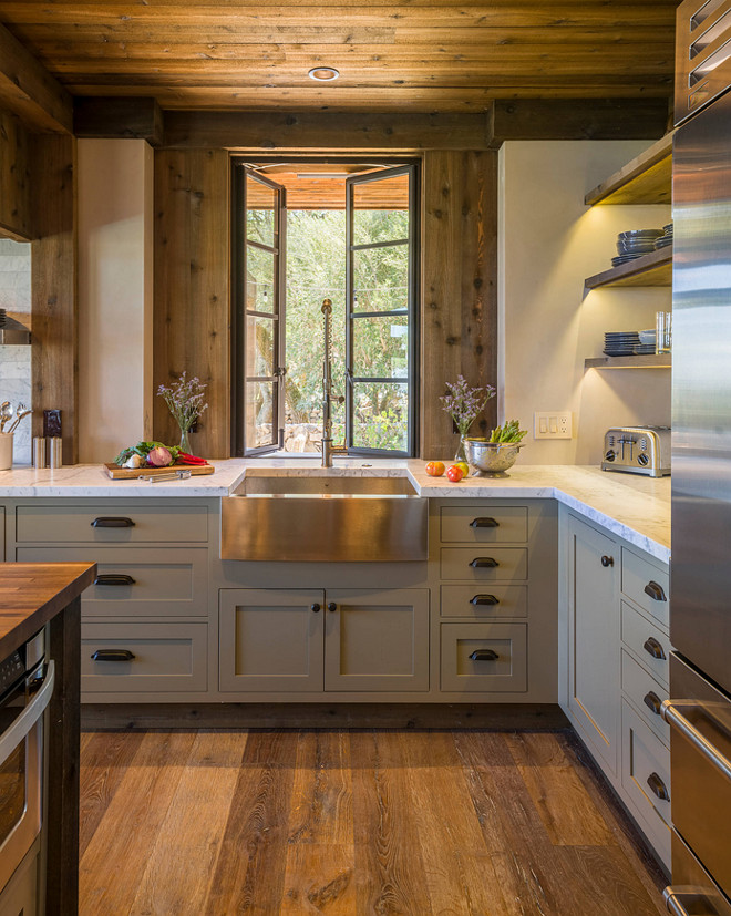 Rustic Kitchen. Rustic Kitchen with Gray cabinet painted in Benjamin Moore Gettysburg Grey HC 107 . The door style is Inset. The wide plank floors are European Oak that is wired brushed. The company is Provenza, Pompeii collection and the color is Amiata. The kitchen faucet is Kraus, model KPF-1602. The window manufacturer is Bloomberg. The stainless steel farmhouse sink is Krauss, model KHF200-30. The counter is carrara marble. This rustic kitchen features reclaimed wood on ceiling and as wall accent. The wood is cedar that's been treated to look distressed. #RusticKitchen #Reclaimedwood #RusticKitchenWood #RusticKitchenColoe #RusticKitchenPaintcolor #RusticKitchenSink #RusticKitchenFaucet #RusticKitchenFlooring Barbra Bright Design