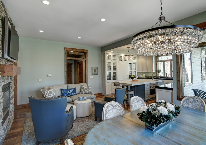 The kitchen and dining area features a Robert Abeey Bling Chandelier in deep patina bronze. Benchmark Wood & Design Studios 