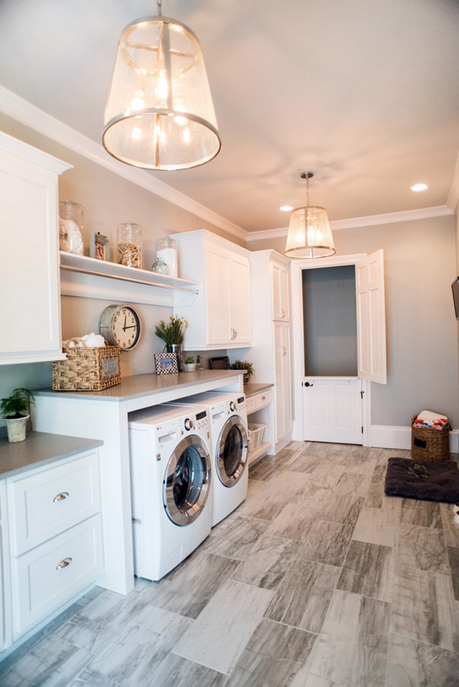 Laundry room. Laundry room flooring is porcelain tiles. Laundry room lighting is from Circa Lighting. Laundry room Countertop is. Caesarstone Pebble Honed Quartz. Laundry Room Paint Color is Sherwin Williams Silverplate. #LaundryRoom Distinctive Remodeling Solutions, Inc.