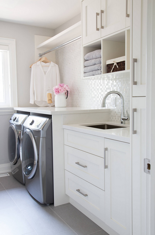 Laundry room tile and backsplash. Crisp white laundry room with white quartz countertop, porcelain floor tiles and white backsplash tile. Floor tile is: Porcelain Grigio Floor MT35R 12x24 Backsplash is: Onix Opalo Blend 13.25x13.25 both were purchased from Weston Tile. #Laundryroom #Laundryroomtiles #Laundryroombacksplash #Laundryroomfloortile #Laundryroombacksplashtile #Laundryroom barlow reid design