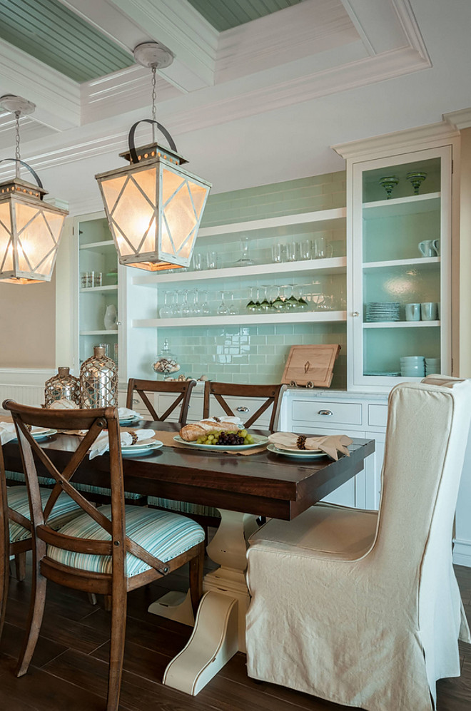 This dining room features a built in buffet for storage. The built in buffet paint color is Dunn-Edwards DEW380 White. Glass tile backsplash is The backsplash tile is Northshore Glass - 3"x6" flat. Color: White Rock. #Diningroom #Diningroombuffet #Diningroomhutch #Diningroombuiltin #Diningroomcabinet #diningroomcabinetstorage #diningroomstorage QualCraft Construction Inc