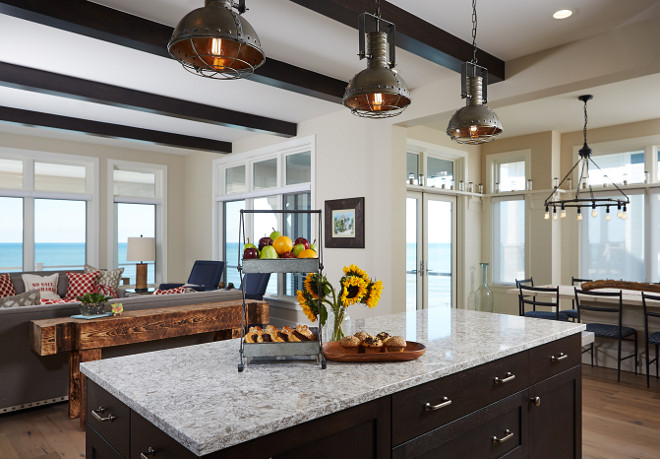 Kitchen island. Kitchen island stone counter is New Wuay Cambria Quartz and dropped island table is pine stained with a slight distressing finish. Mike Schaap Builders