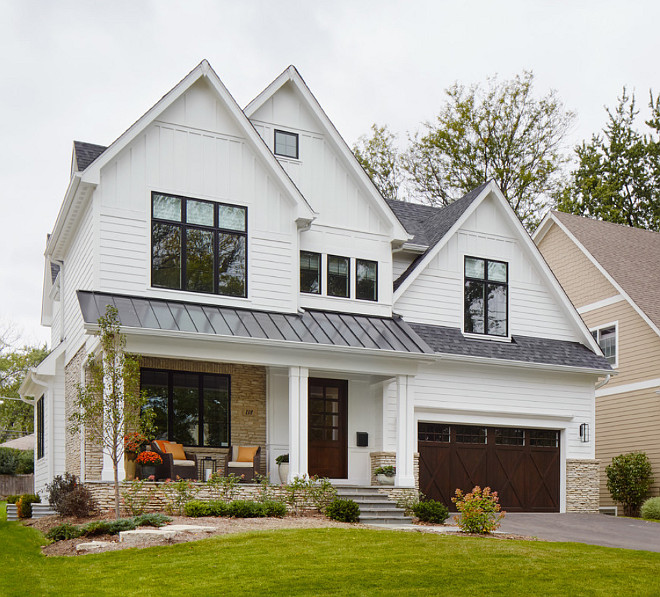 White exterior with black steel windows and metal roof. Summit Signature Homes, Inc