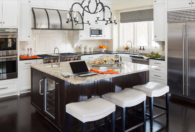 White kitchen with walnut stained kitchen and walnut stained flooring. Walnut island. White kitchen cabinets with walnut island. #Whitekitchen #walnutisland #walnutflooring Martha O'Hara Interiors