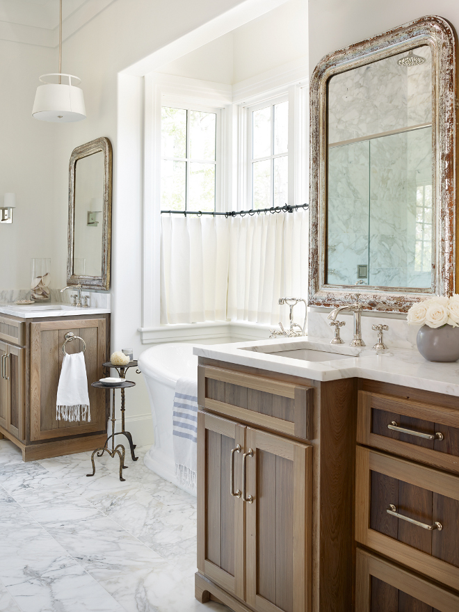 Rustic Bathroom Cabinet. This bathroom is a mix of elegance with rustic elements that keeps this space balanced. Cabinetry is reclaimed Cypress. Marble countertop is Calcutta Gold. Hardware is by Rocky Mountain Hardware. Rustic bathroom cabinet ideas. #RusticBathroom #RusticBathroomwoodCabinet #Rusticbathroomcabinet #Rusticbathroomcabinetideas #RusticBathroomwoodCabinetry Interiors by Courtney Dickey of TS Adams Studio