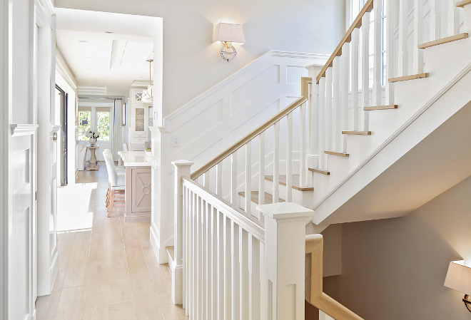 Staircase millwork and flooring. I love the light color wood floor (white oak) with the white staircase millwork. #lightwoodfloor Patterson Custom Homes. Interiors by Trish Steele, Churchill Design.