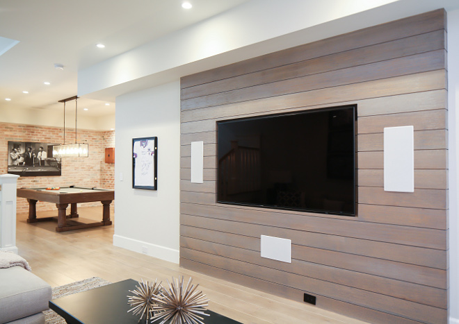 The tv room features a whitewashed shiplap accent wall. Patterson Custom Homes. Interiors by Trish Steele, Churchill Design.