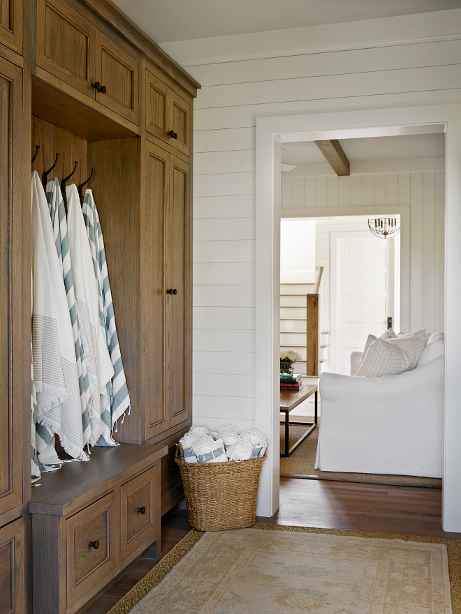 Reclaimed white oak cabinet. Just off the family room, this cozy mudroom features beautiful graywashed reclaimed white oak cabinets and shiplap walls. Rug is vintage. #Mudroom #graywashedcabinet #graywashedreclaimedwhiteoak #graywashedreclaimedwhiteoakcabinet #reclaimedwhiteoakcabinet T.S. Adams Studio, Architects