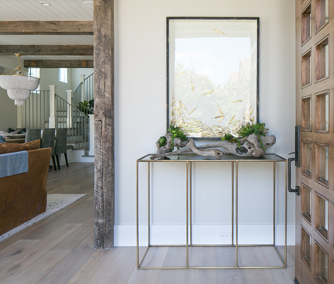 Entry. Foyer entry ideas. Brass accents and reclaimed wood make for the perfect pair in this entry. Notice the gorgeous gold feather art. #Foyer #Entry Patterson Custom Homes