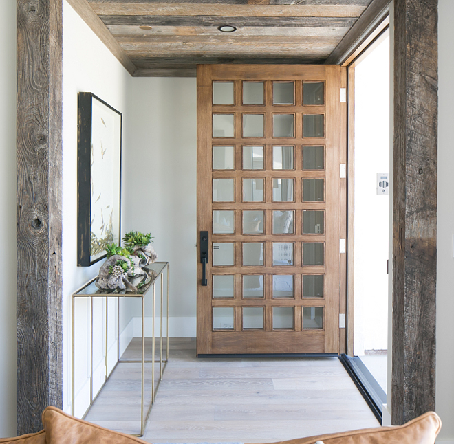 Front Door. Wood and Glass Front Door. Wood and glass door. Front door is custom made by the builder's local finish carpenter. It is a custom solid stain grade wood door with a translucent black stain and clear glass with an anodized aluminum threshold. #FrontDoor #door #wooddoor #woodenfrontdoor #woodenandglassfrontdoor Patterson Custom Homes