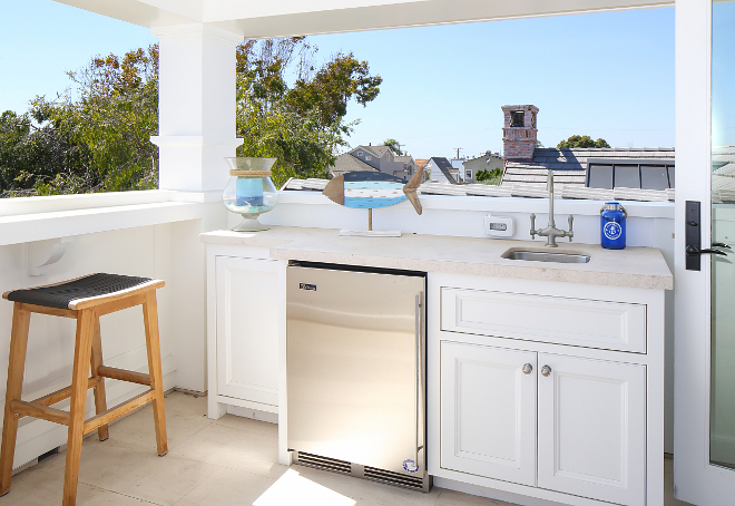 Outdoor kitchen with beverage fridge. A beverage fridge keep drinks cool and handy. Patterson Custom Homes. Interiors by Trish Steele, Churchill Design.