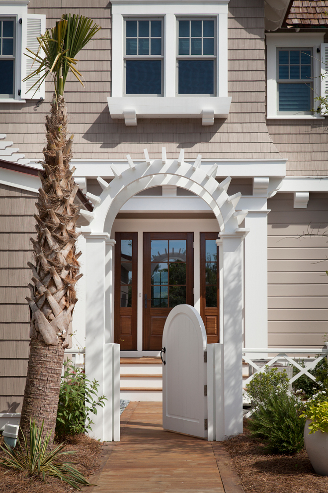 Fenced front yard. Fenced Homes. A fenced and gated front entry provides some privacy and security to this beach house. #Fence #FencedFrontyard #GatedFrontyard #gate #HomeGates T.S. Adams Studio, Architects 