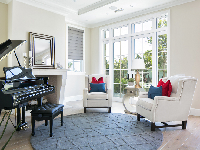 Living room French Doors. French doors with sidelights and transoms bring plenty of natural light in, and creates a feeling of space in this small living room. #livingroom #Frenchdoors #transoms #sidelights Patterson Custom Homes. Brandon Architects, Inc.