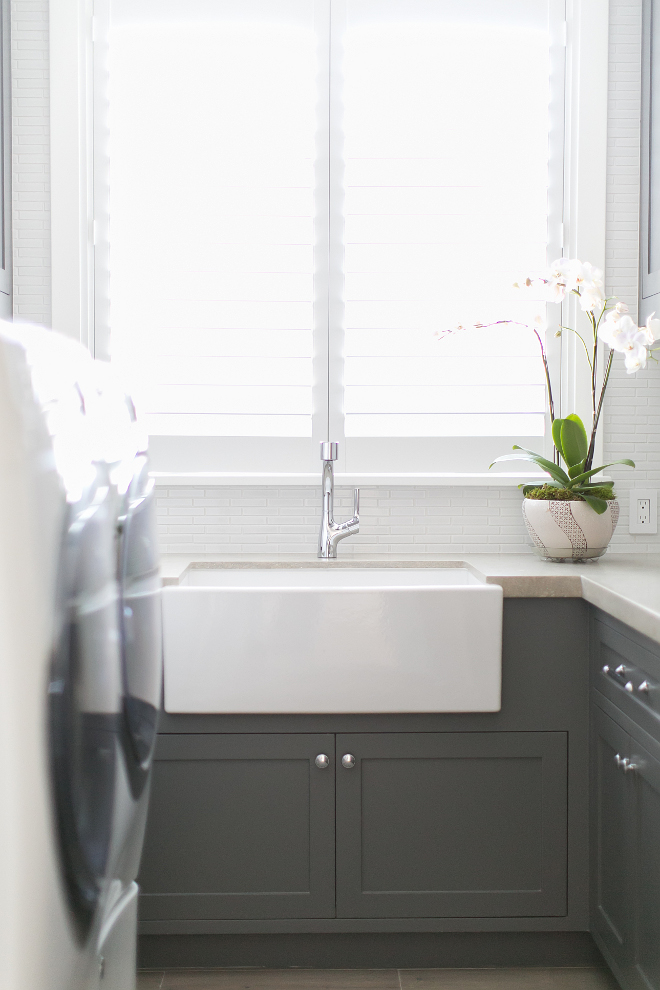 Farmhouse sink in Laundry Room. Laundry room Farmhouse sink. The laundry features a farmhouse sink and limestone countertop. #Farmhousesink #laundryroom #limestone #countertop #laundryroomsink Patterson Custom Homes. Brandon Architects, Inc.