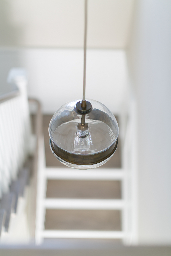 Stairway Lighting. Stairway Lighting Ideas. Modern Stairway Lighting. The stairway lighting is Arteriors Garrison Round Pendant #StairwayLighting Patterson Custom Homes. Brandon Architects, Inc.